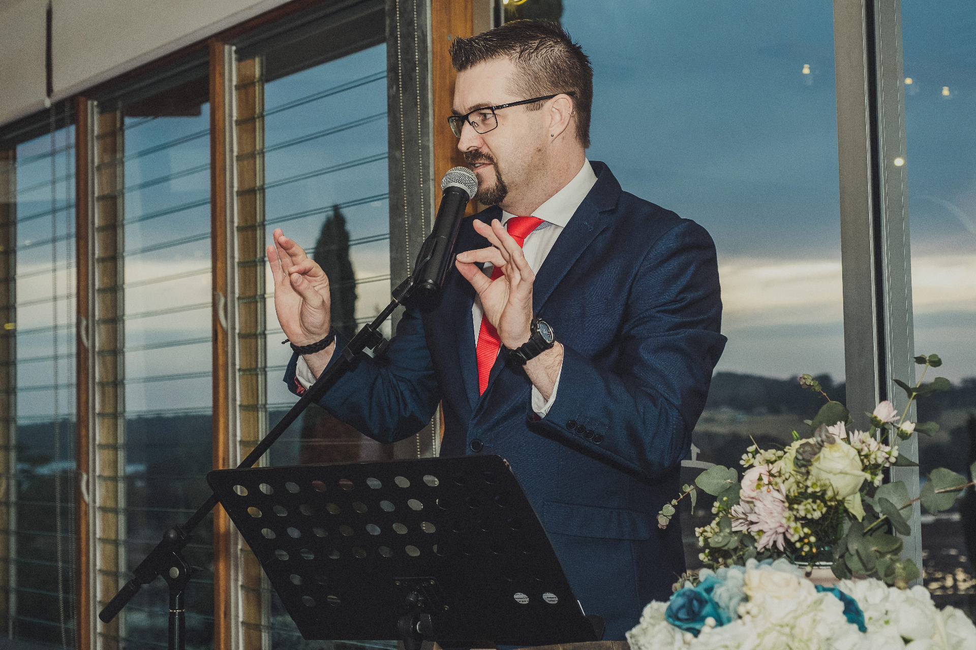 TJ on stage hosting a corporate awards night
